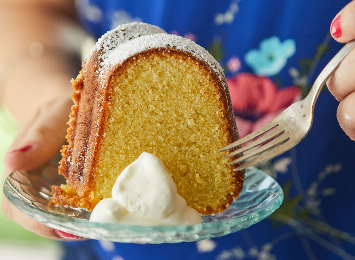 slice of citrus olive oil bundt cake with whipped cream and fork