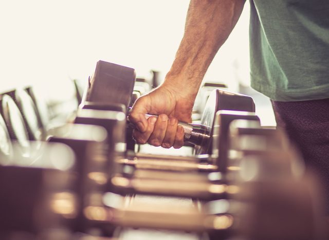 holding dumbbells