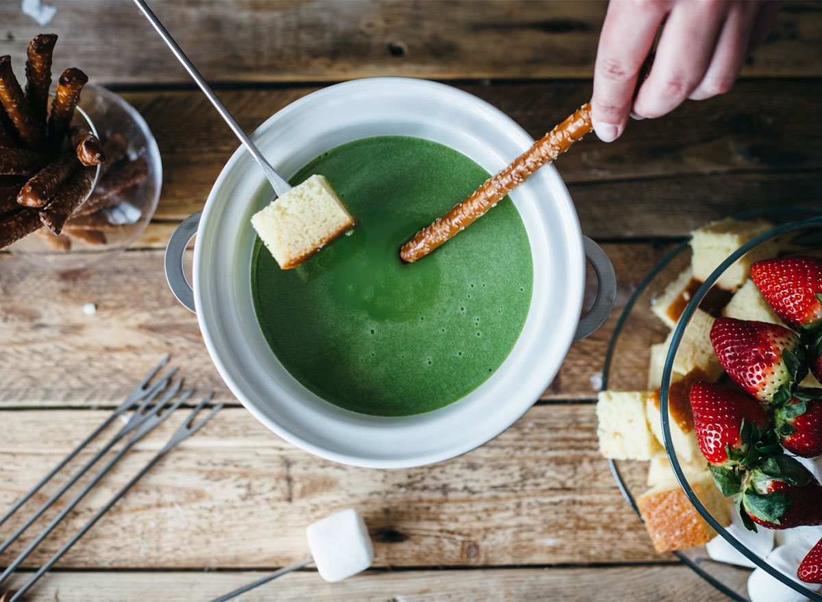 matcha fondue dipping sauce with skewers and bread pieces