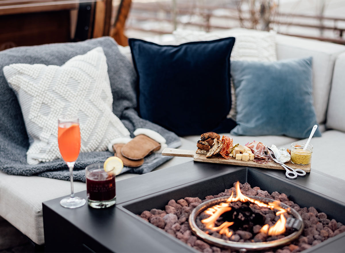 couch and pillows with fireplace