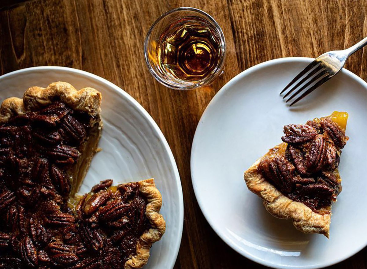 whole pecan pie with slice