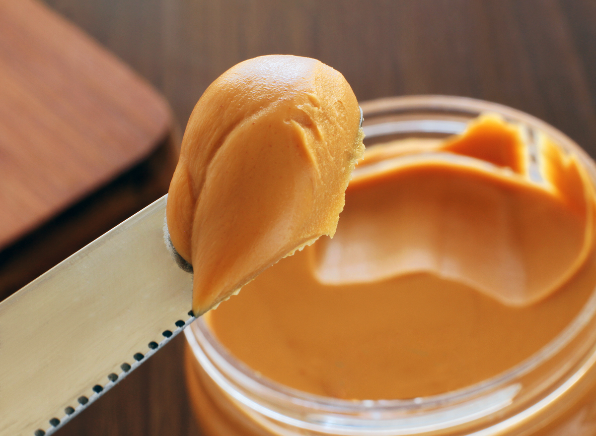 Shutterstock. smooth creamy peanut butter in jar. 