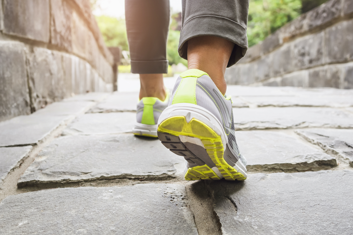 person walking on a stone bridge