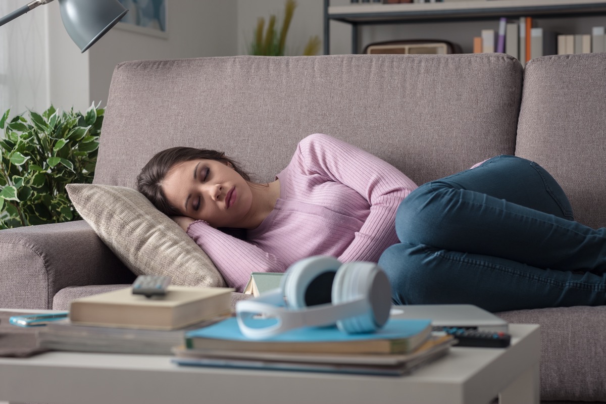 Woman sleeping on the couch in the living room. 