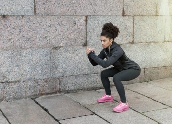 woman doing squats outside