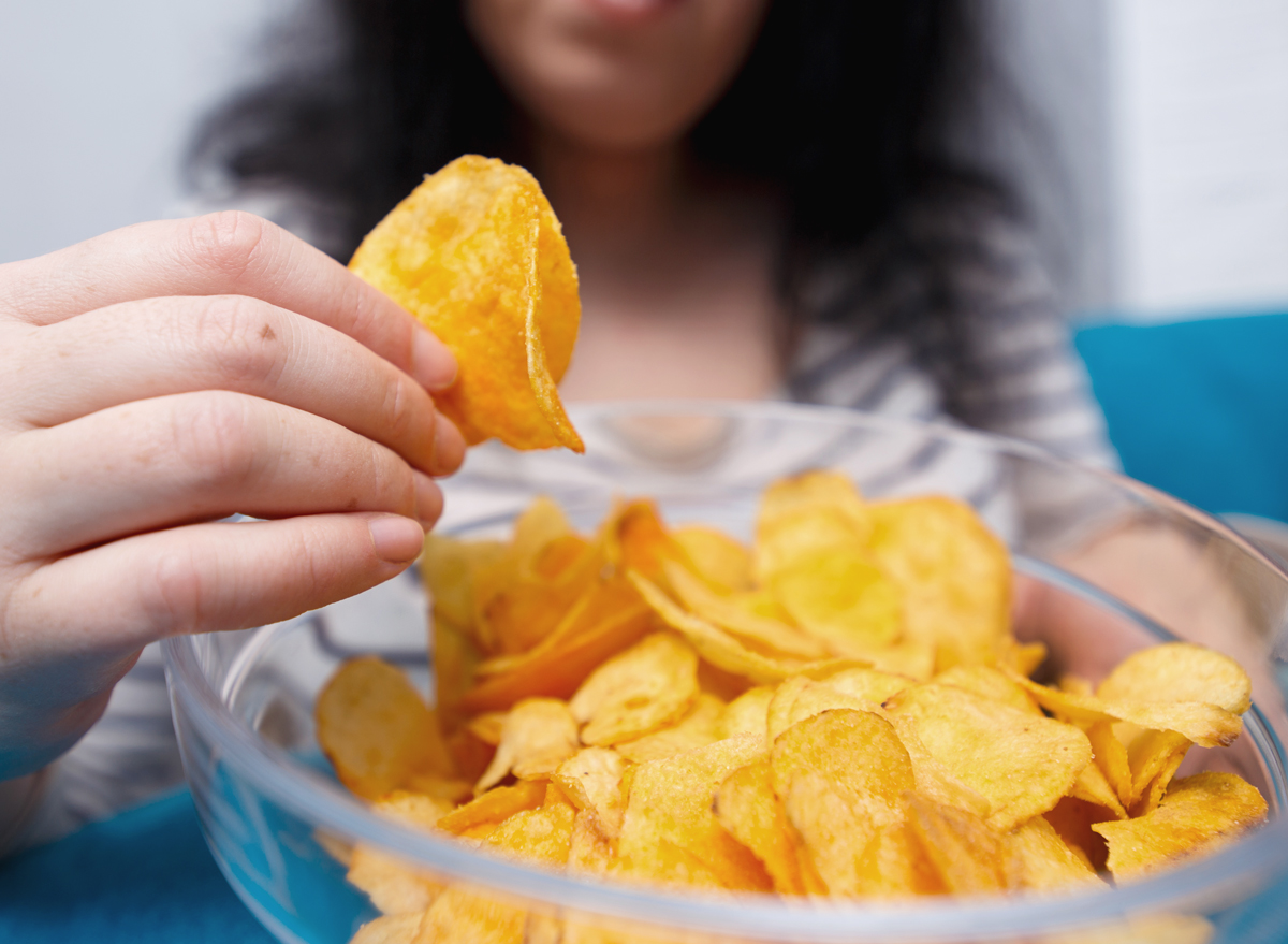 woman eating potato chips