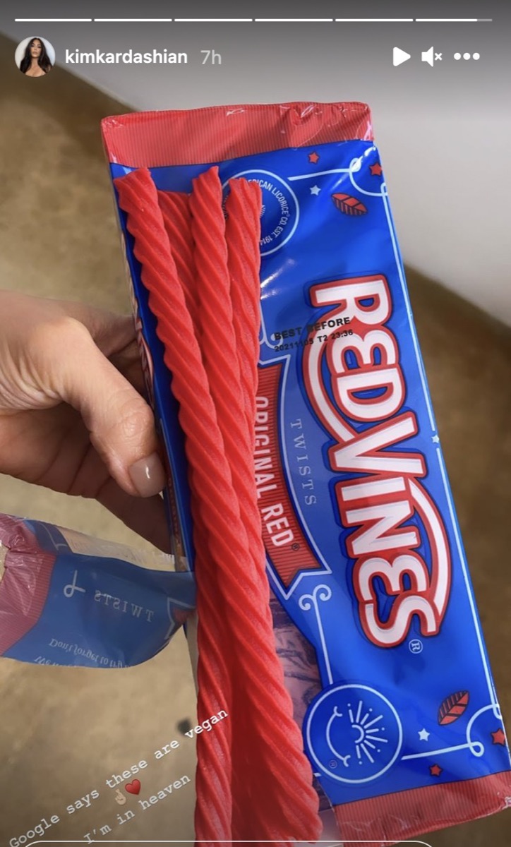 kim kardashian's hand holding a package of red vines candy