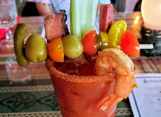 bloody mary topped with celery and tomatoes