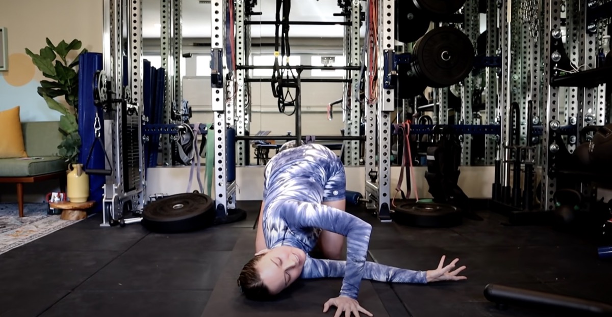 brie larson stretching one arm under her torso