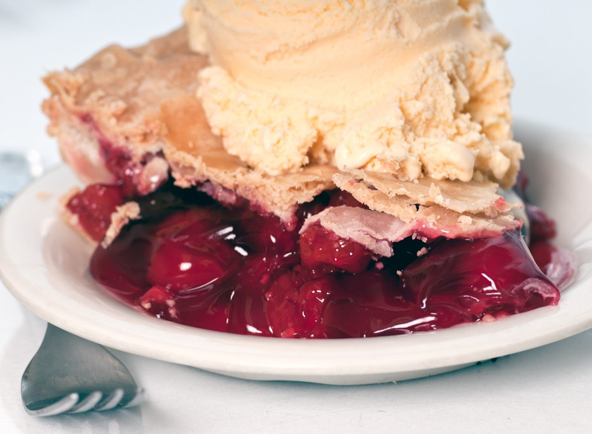 slice of cherry pie topped with ice cream