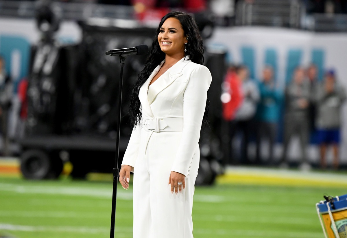demi lovato in a white suit performing at the super bowl