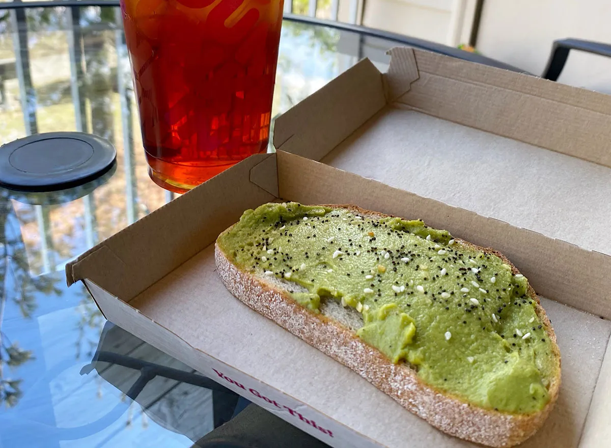 slice of dunkin avocado toast with iced tea