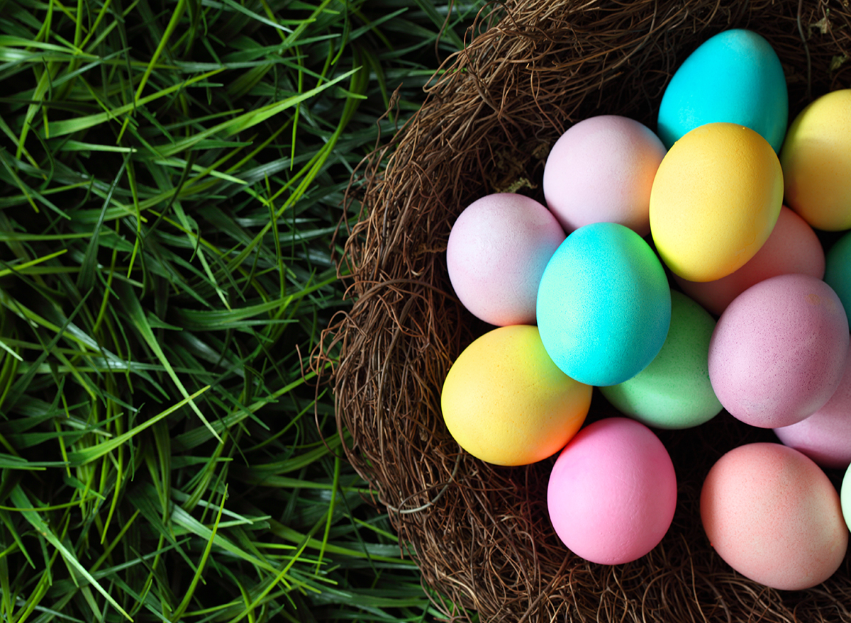 basket of easter eggs on grass