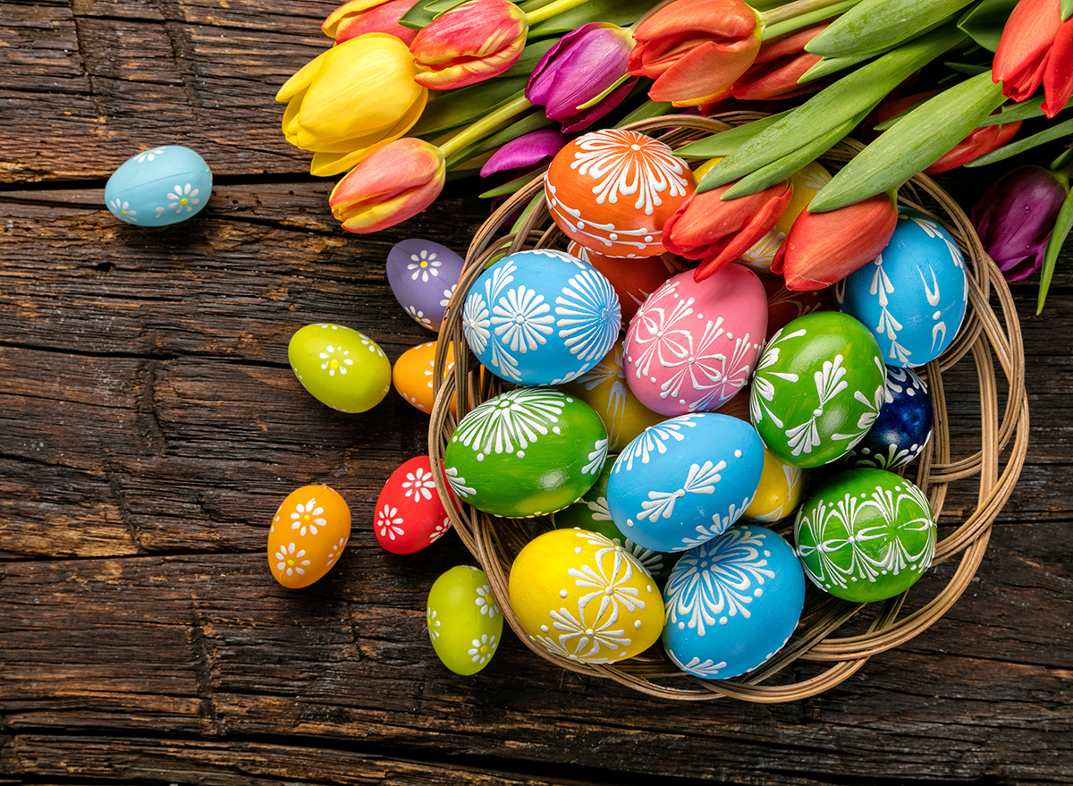 basket of easter eggs with flowers