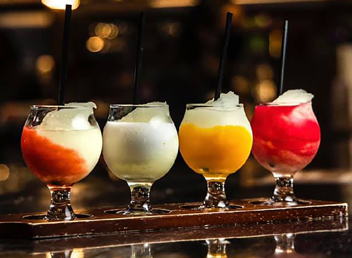 four frozen margaritas on bar