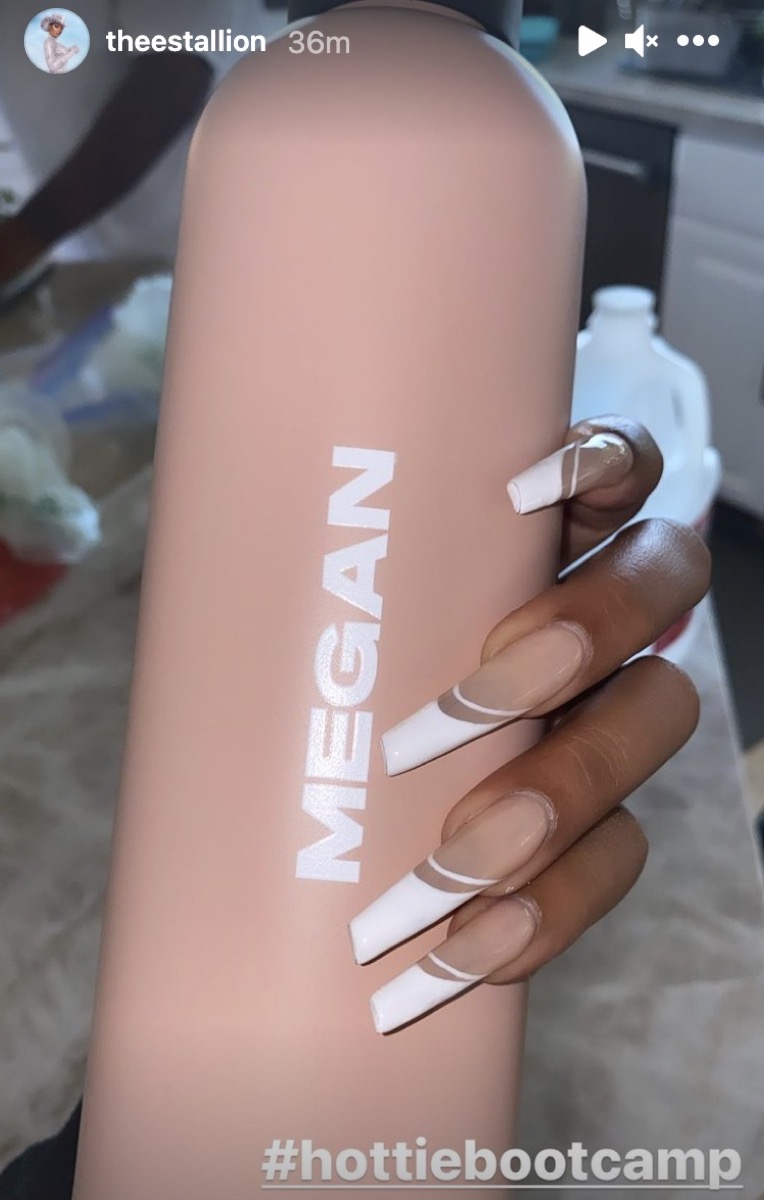 megan thee stallion holding pink water bottle with megan on it