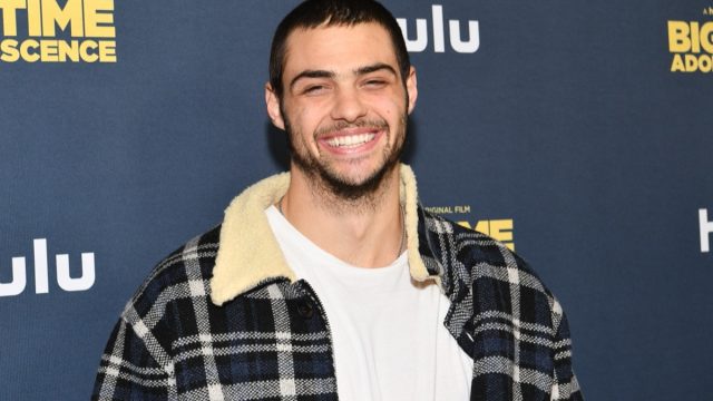 noah centineo in white t-shirt and black plaid sherpa jacket on red carpet