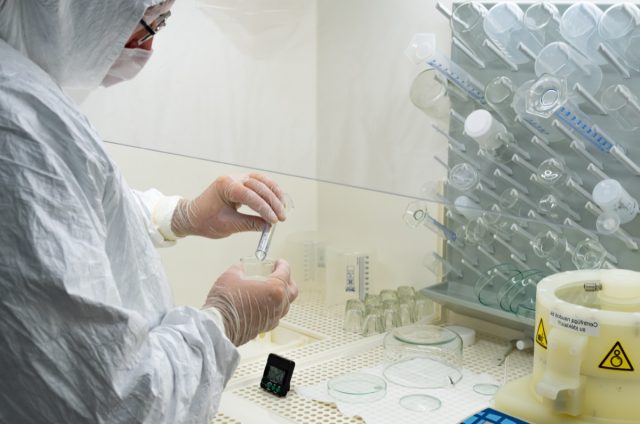 Scientist in laboratory studying and analyzing scientific sample of Coronavirus monoclonal antibodies to produce drug treatment for COVID-19.