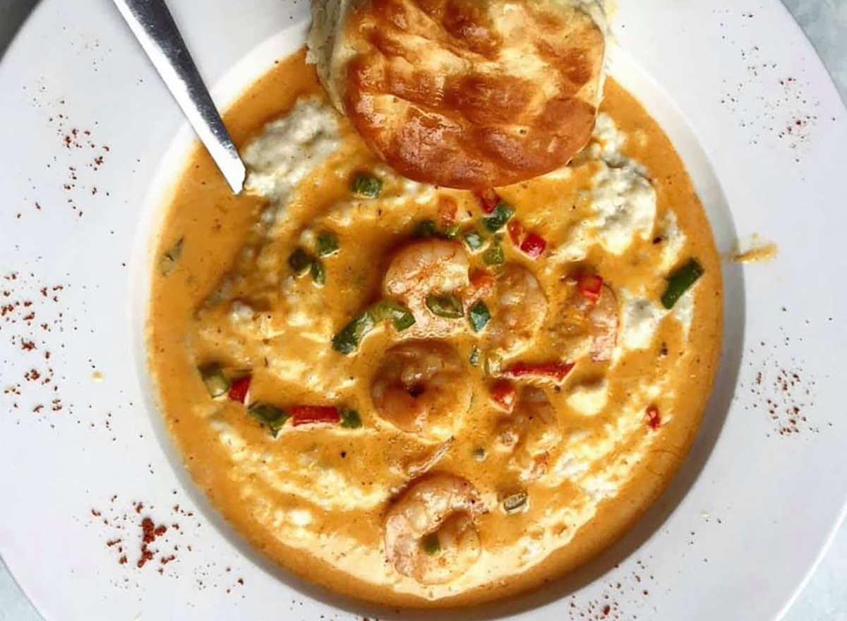 bowl of shrimp and grits with biscuit