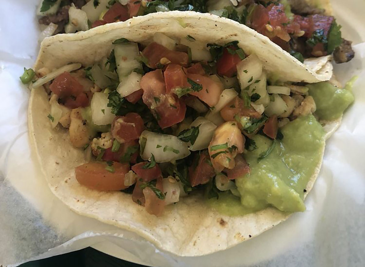 closeup of tacos with pico de gallo and guacamole