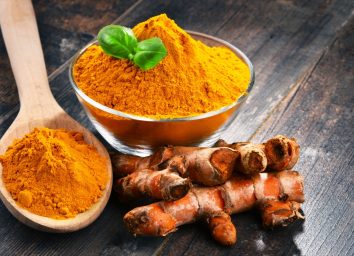 turmeric in bowl and wooden spoon