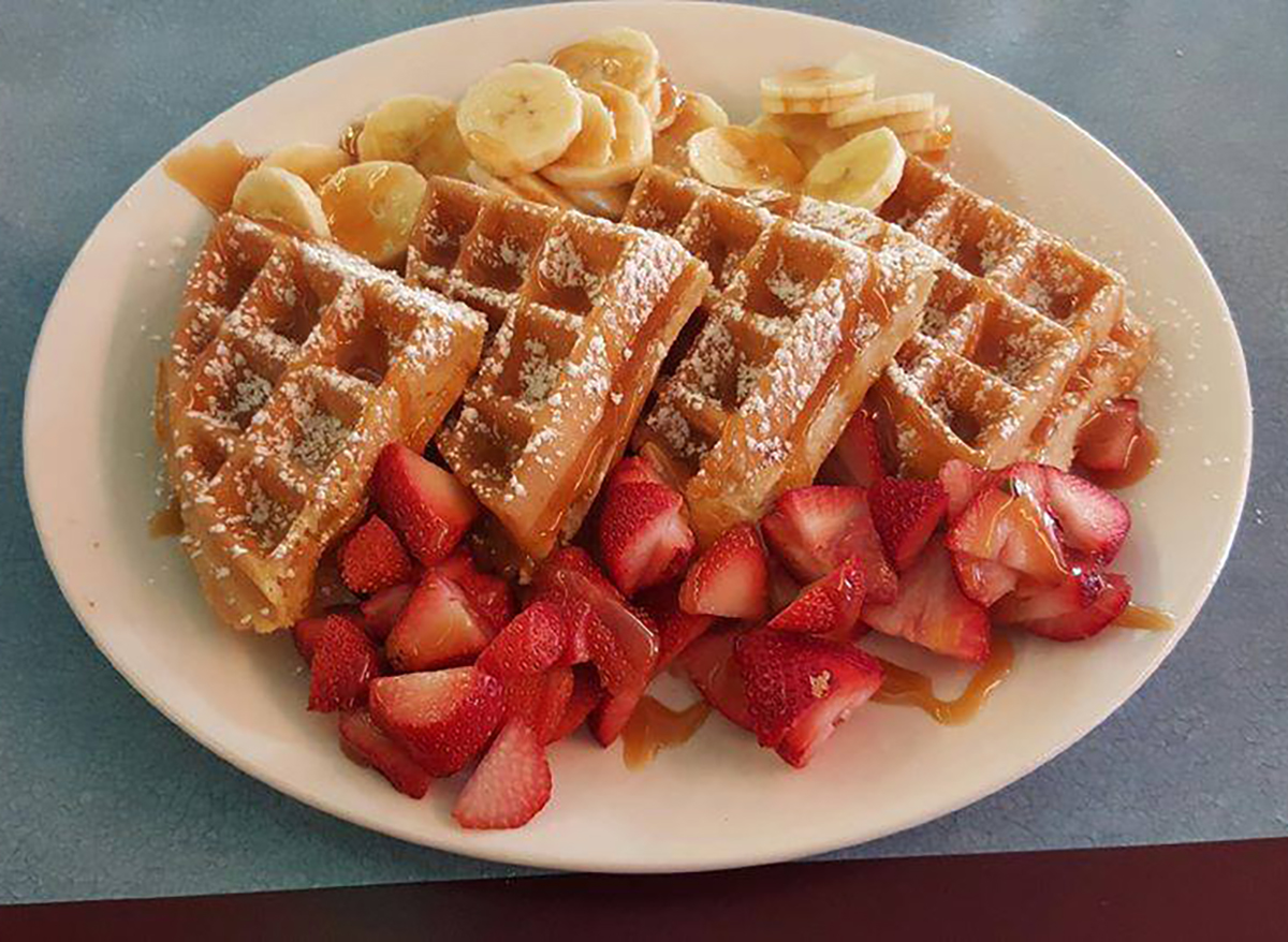 quarters of waffles with banana and strawberry slices