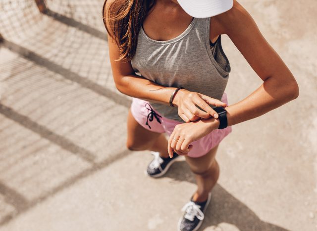 woman checking fitness watch