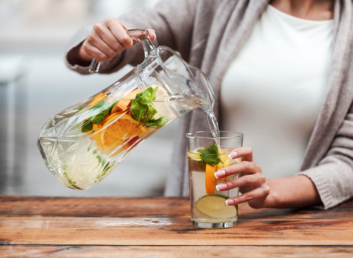 woman pouring fruit water