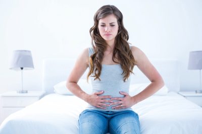 Woman suffering from stomach pain.
