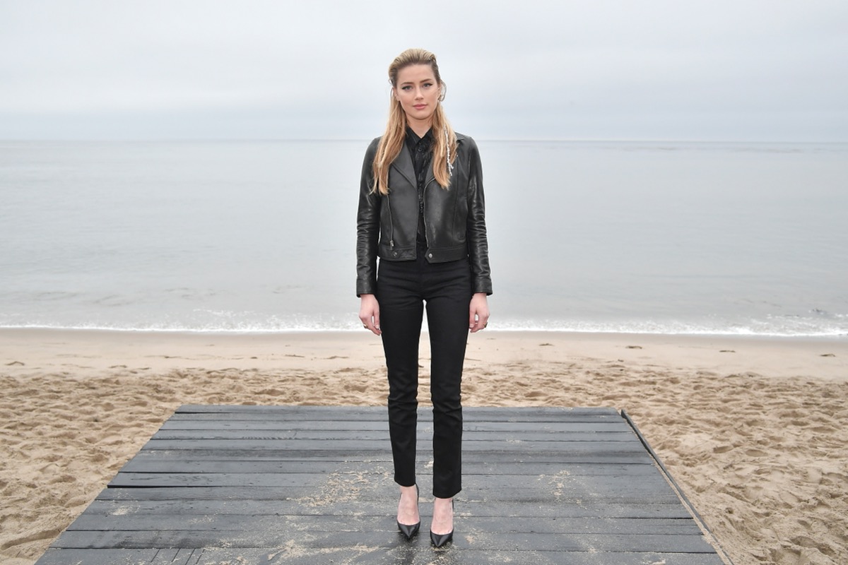 amber heard in black pants and jacket on the beach