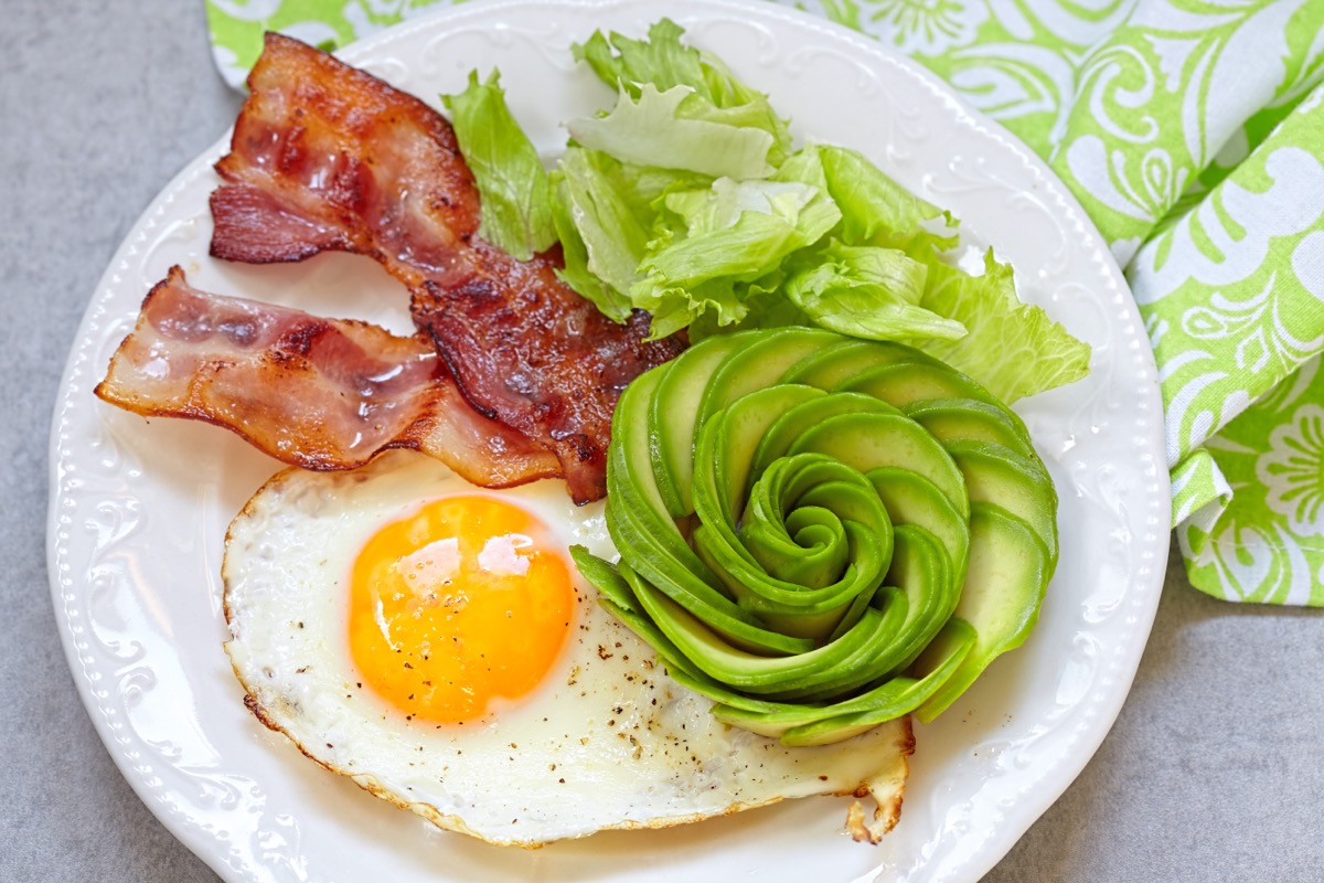 bacon, eggs, and avocado flower on plate