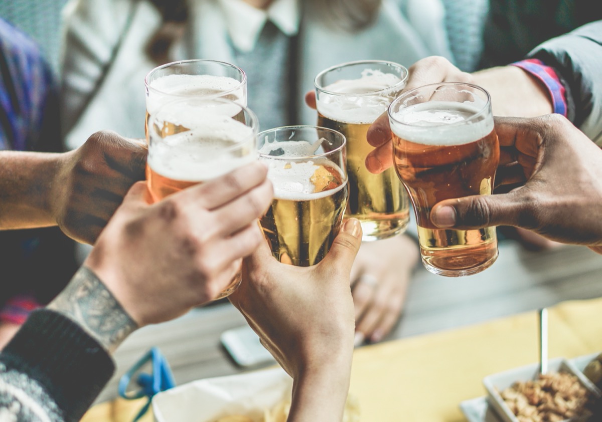 group of friends toasting with glasses of beer