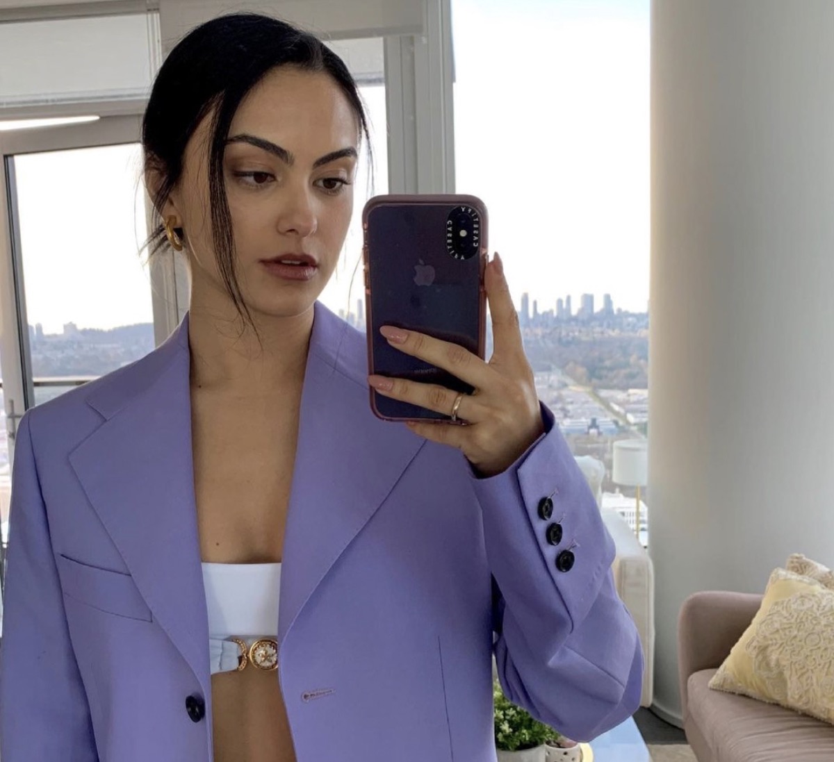 camila mendes taking selfie in purple jacket