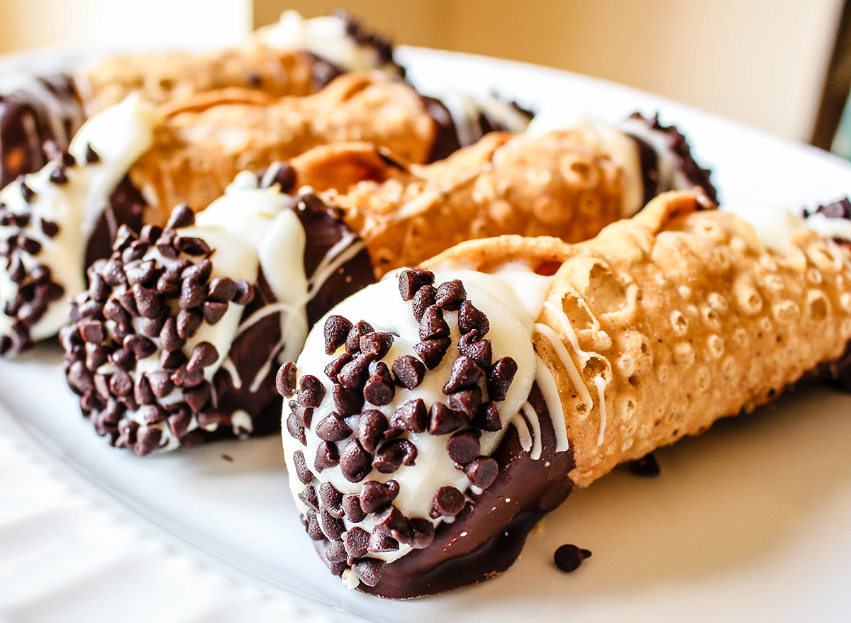 row of cannolis with chocolate chips on plate