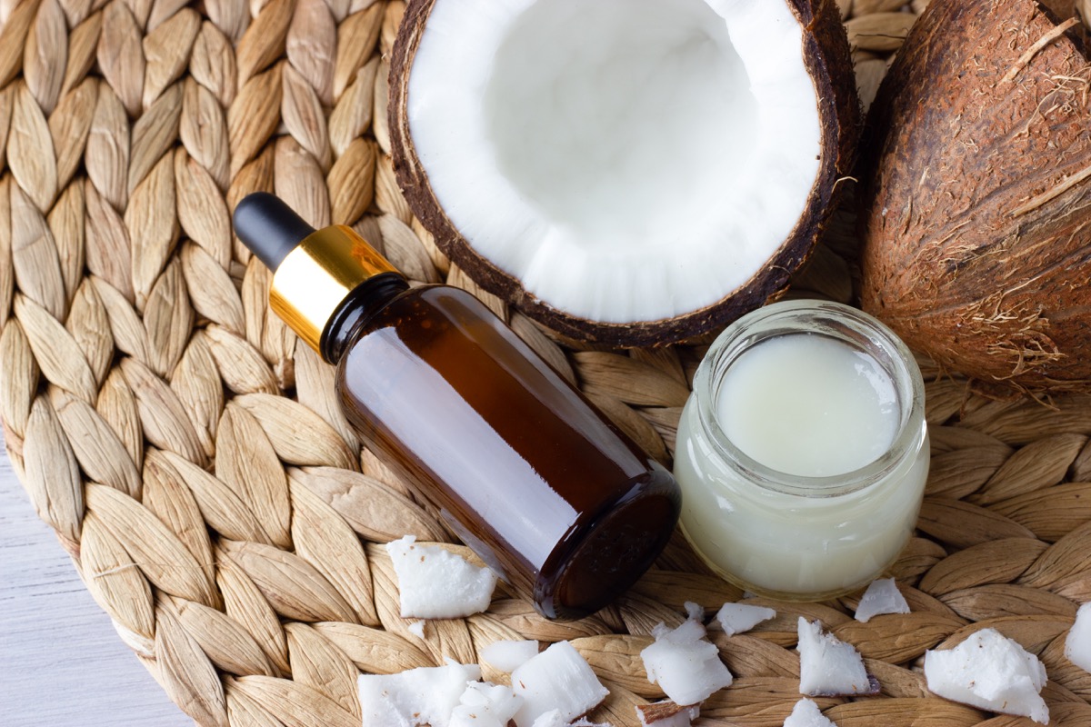 Coconut oil and fresh coconuts on the wooden table