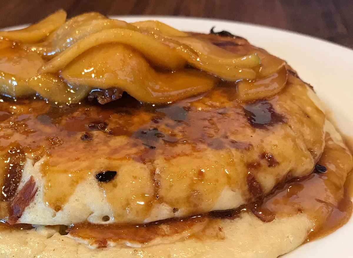 stack of cinnamon apple pancakes topped with bacon