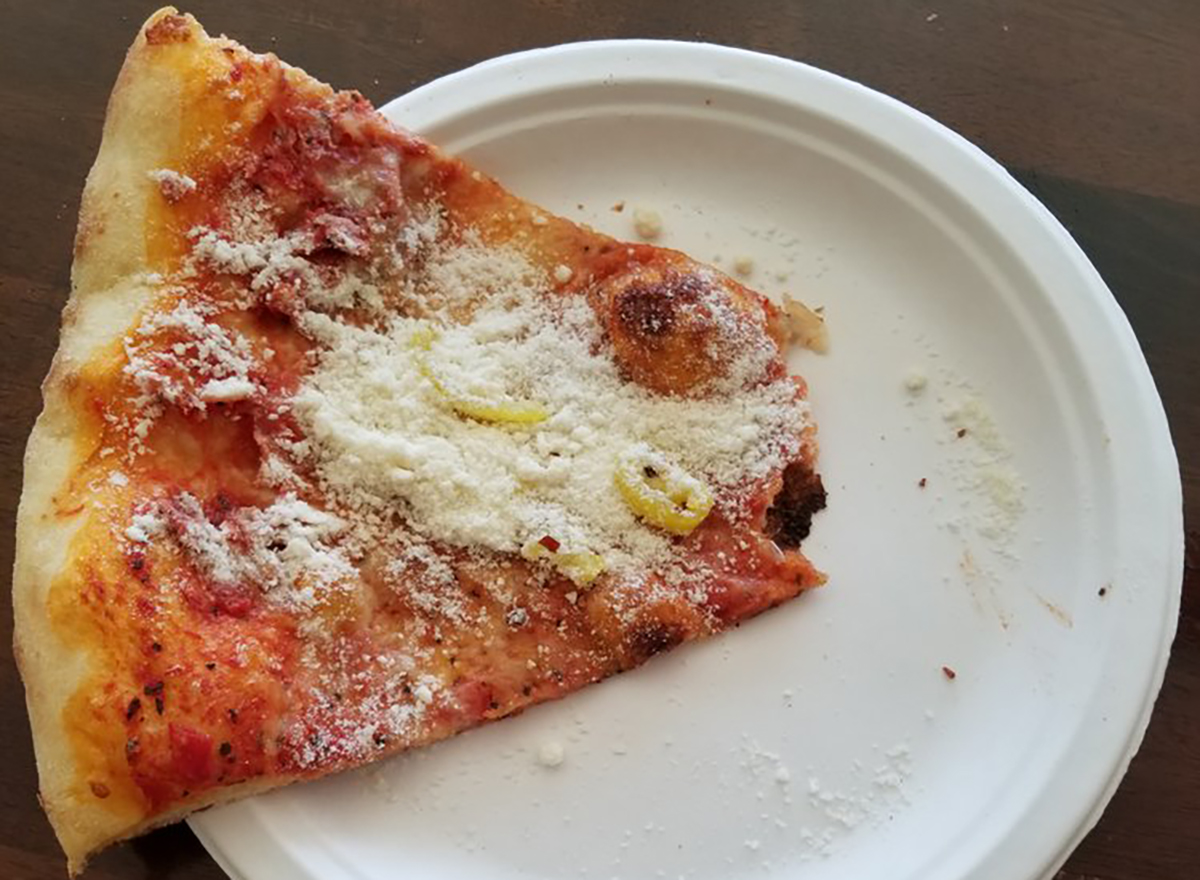 slice of pizza topped with parmesan chees