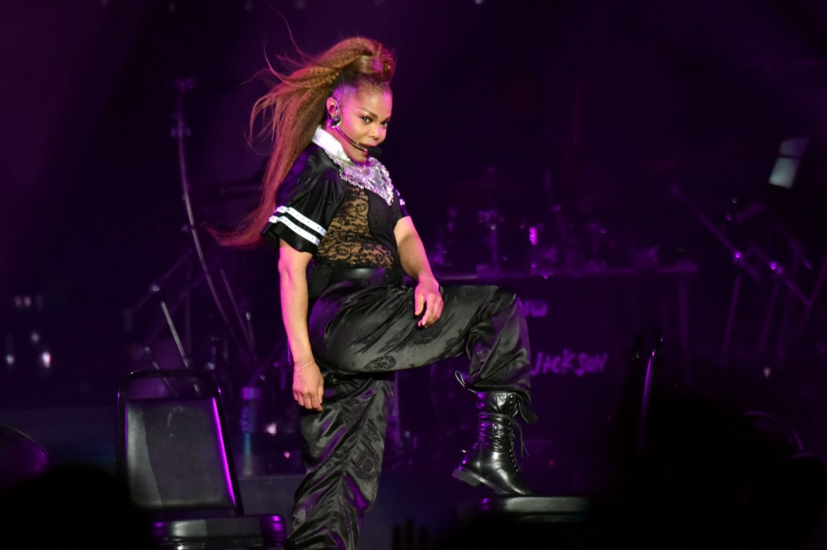 janet jackson in high ponytail and black outfit dancing