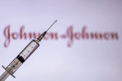 Syringe Injection placed against Johnson and Johnson logo