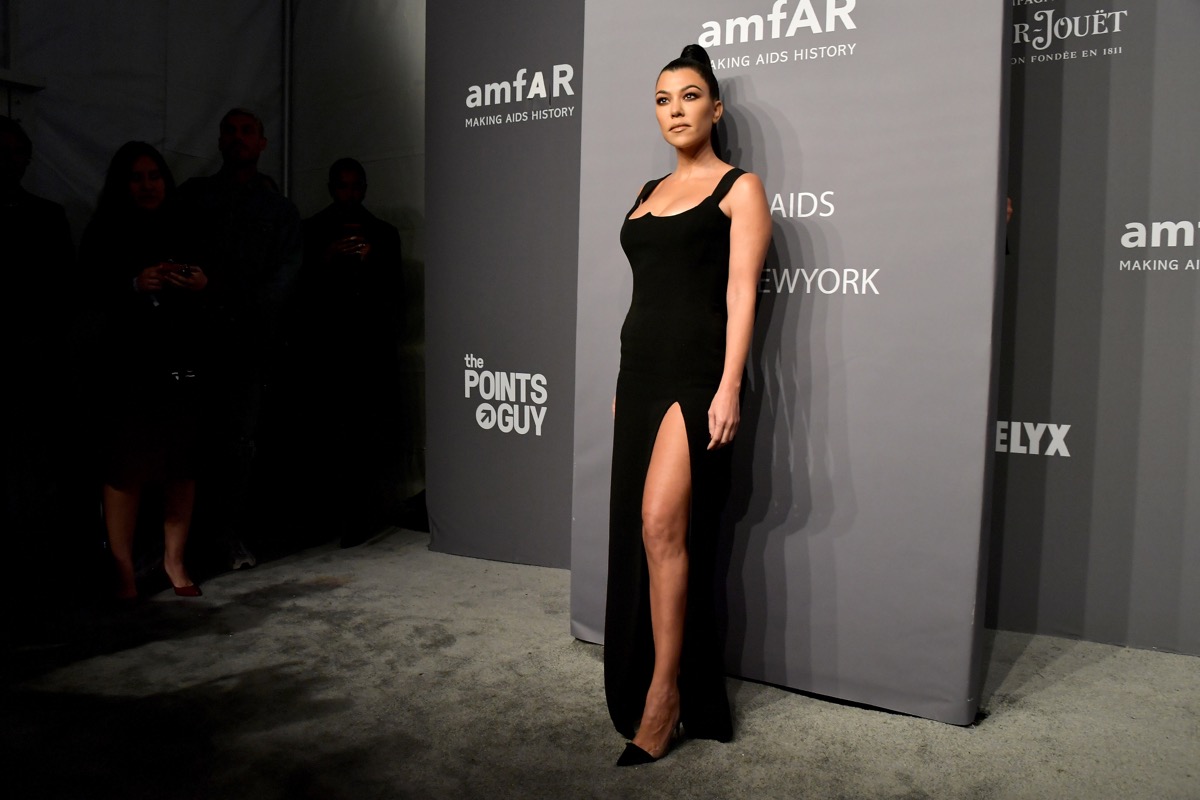 kourtney kardashian in black dress with high slit