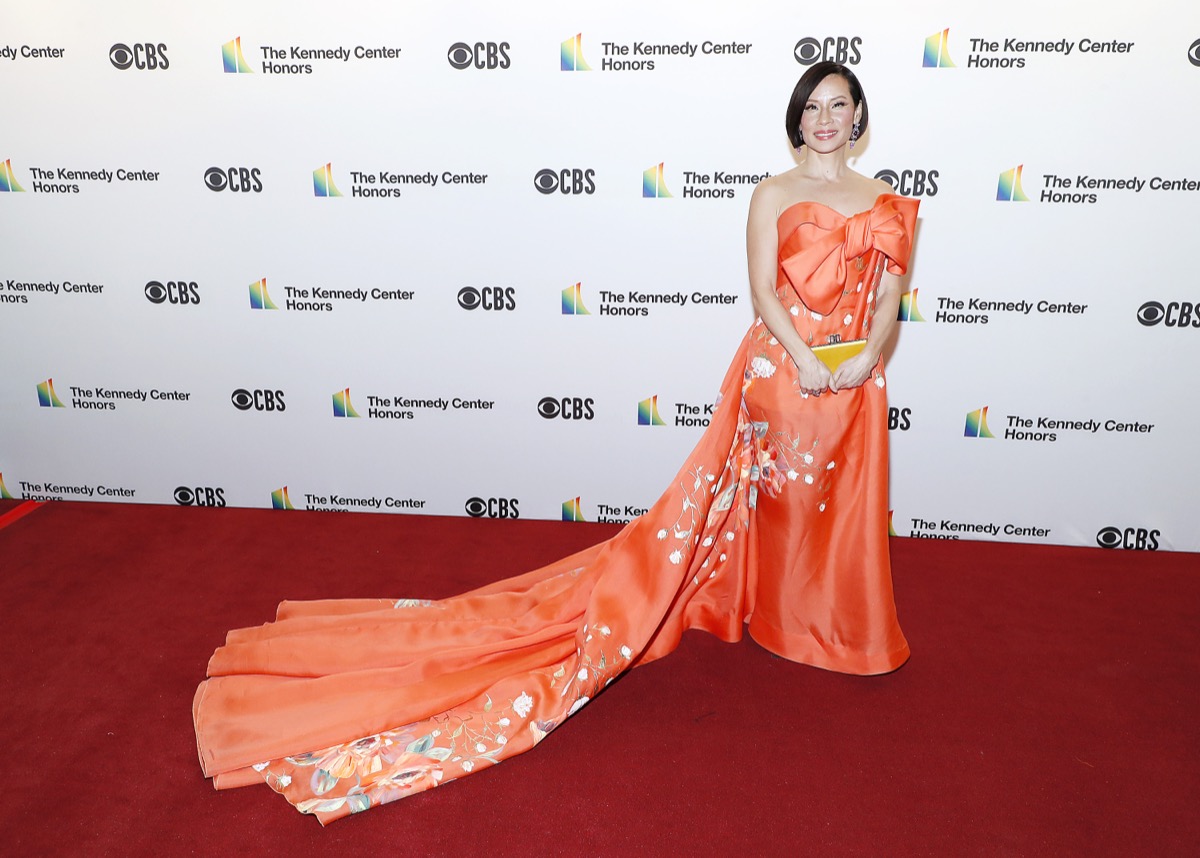 lucy liu in long orange dress on red carpet