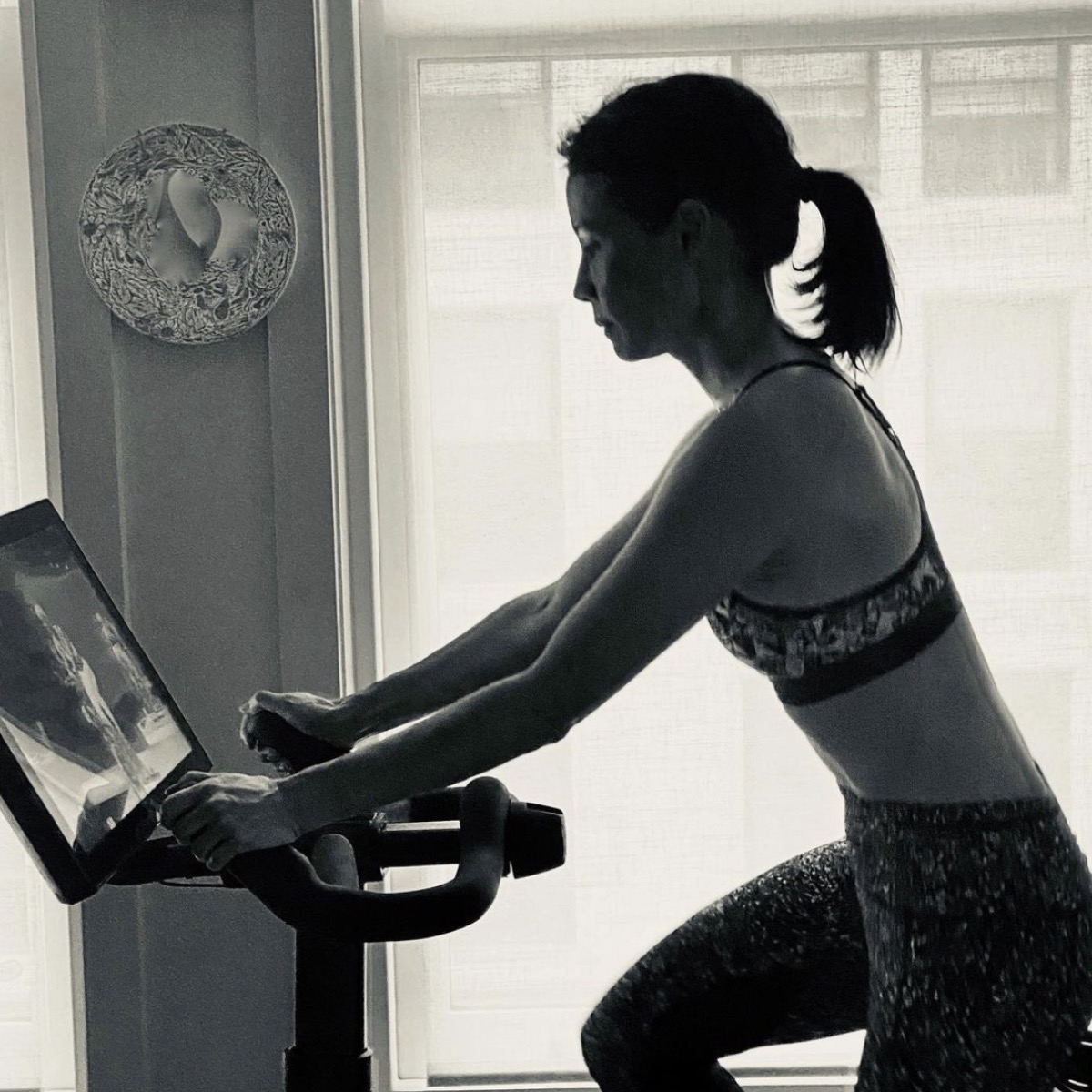 lucy liu in black and white photo on soulcycle or variis bike