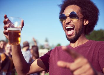 Screaming African man drinking beer at the music festival