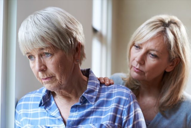 senior woman with adult daughter at home.