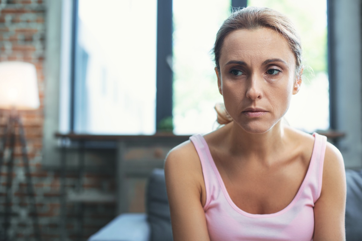Worried mature woman at her home.