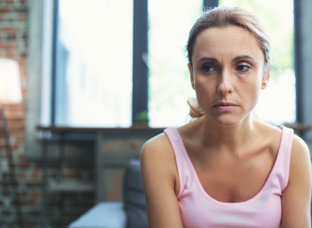 Worried mature woman at her home.