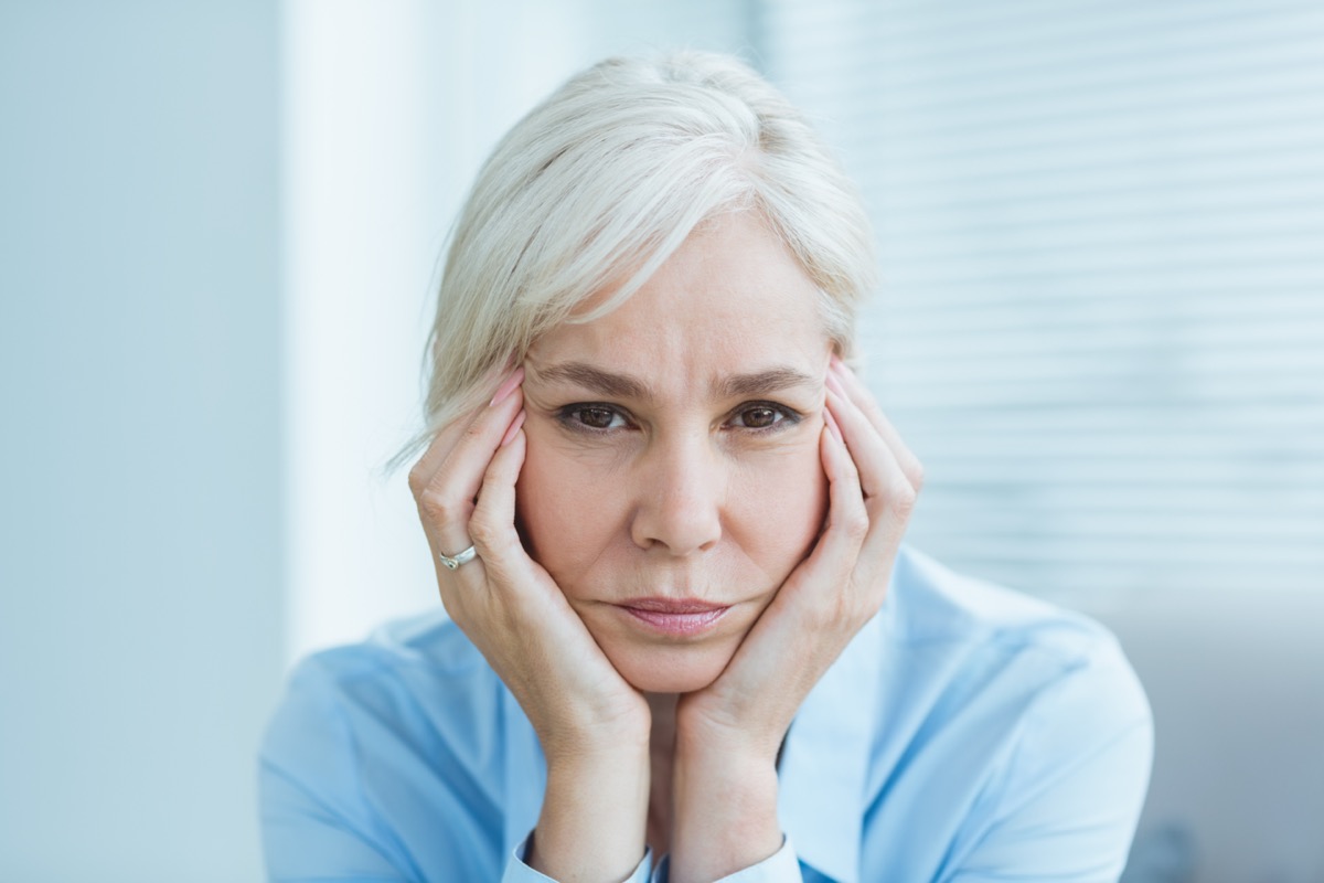 Portrait of sad senior woman at home