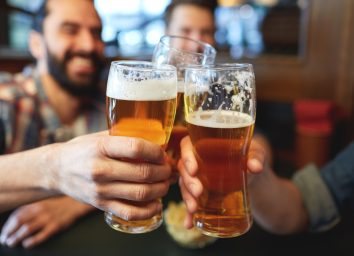 men drinking beer at a bar