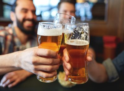 men drinking beer at a bar