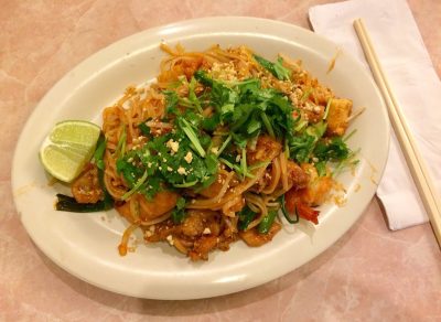 pad thai topped with cilantro and served with lime wedge